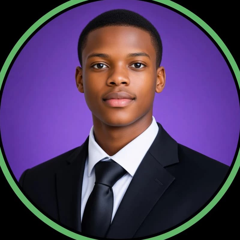 Portrait of Adex wearing a dark suit and tie